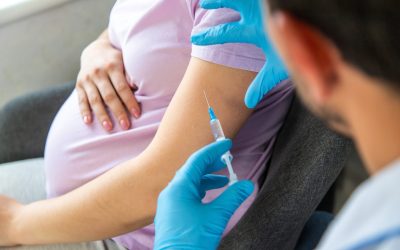 A pregnant woman makes a vaccination. Selective focus. doctor.